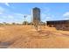 Large metal grain silo for feed storage with windmill at 29315 N 140Th St, Scottsdale, AZ 85262