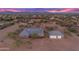 Aerial view of a single-story home with a detached garage and expansive desert landscape at 29315 N 140Th St, Scottsdale, AZ 85262