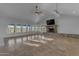 Bright living area with tile floors and a stone fireplace, bathed in sunlight at 29315 N 140Th St, Scottsdale, AZ 85262