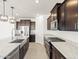 Spacious kitchen with granite countertops and dark cabinets at 3530 E Alexander Dr, San Tan Valley, AZ 85143
