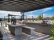 Outdoor grilling station with built-in seating and a pergola at 3530 E Alexander Dr, San Tan Valley, AZ 85143