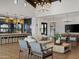 Open concept community room with a kitchen, seating area, and fireplace at 3530 E Alexander Dr, San Tan Valley, AZ 85143