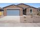 Newly built home features a two-car garage and desert landscaping at 3530 E Alexander Dr, San Tan Valley, AZ 85143