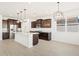 Modern kitchen with island, stainless steel appliances, and dark cabinetry at 3530 E Alexander Dr, San Tan Valley, AZ 85143