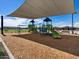 playground with swings and climbing structures under shade sail at 3530 E Alexander Dr, San Tan Valley, AZ 85143