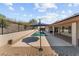 Relaxing pool area with patio, umbrella, and rock landscaping at 540 Atchison Ln, Wickenburg, AZ 85390