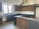 Modern kitchen featuring a large island, stainless steel appliances, and expansive windows at 507 E Mountain View Rd, Phoenix, AZ 85020