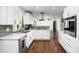 Modern kitchen with white cabinets, marble countertops, and stainless steel appliances at 10808 N 43Rd St, Phoenix, AZ 85028