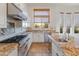 Kitchen with granite counters, white cabinets and stainless steel appliances at 41253 N Whistling Strait Ct, Anthem, AZ 85086