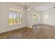Bright dining room with large windows, tile floor, and modern chandelier at 41253 N Whistling Strait Ct, Anthem, AZ 85086