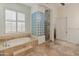 Primary bathroom with soaking tub, glass block shower, and tile flooring at 41253 N Whistling Strait Ct, Anthem, AZ 85086