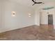 Open living room with tile floors and ceiling fan at 41253 N Whistling Strait Ct, Anthem, AZ 85086