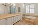 Spa-like bathroom with double vanities, soaking tub, and glass block shower at 41253 N Whistling Strait Ct, Anthem, AZ 85086