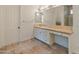 Bathroom features a vanity with drawers, a large mirror, and tiled flooring at 41253 N Whistling Strait Ct, Anthem, AZ 85086