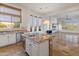 Open kitchen with large island, white cabinets, and views to Gathering room at 41253 N Whistling Strait Ct, Anthem, AZ 85086