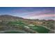 Golf course community with mountain views at sunset at 41253 N Whistling Strait Ct, Anthem, AZ 85086