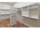 Large walk-in closet with built-in shelving and hanging rods at 41253 N Whistling Strait Ct, Anthem, AZ 85086