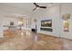 Open concept living room with a kitchen and fireplace at 41253 N Whistling Strait Ct, Anthem, AZ 85086