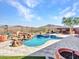 Inviting pool with waterfall feature and expansive patio at 3220 W Feather Sound Dr, Anthem, AZ 85086