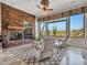 Relaxing living room features a stone fireplace and large windows at 3220 W Feather Sound Dr, Anthem, AZ 85086