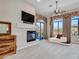 Primary bedroom with fireplace and access to backyard at 3220 W Feather Sound Dr, Anthem, AZ 85086