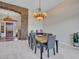 Elegant dining room with a chandelier and stone accents at 3220 W Feather Sound Dr, Anthem, AZ 85086