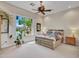 Bright bedroom with a ceiling fan and large window at 3220 W Feather Sound Dr, Anthem, AZ 85086