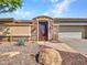 Inviting exterior with a stone facade, wrought iron gate, and landscaped walkway at 3220 W Feather Sound Dr, Anthem, AZ 85086