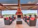 Relaxing patio with seating area and a fireplace at 3220 W Feather Sound Dr, Anthem, AZ 85086