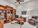 Home office with built-in bookshelves and comfortable seating at 3220 W Feather Sound Dr, Anthem, AZ 85086