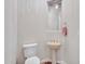 Elegant powder room with pedestal sink and decorative mirror at 3220 W Feather Sound Dr, Anthem, AZ 85086