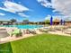 Relaxing resort-style pool with lounge chairs and umbrellas at 3220 W Feather Sound Dr, Anthem, AZ 85086