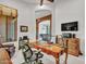 Home office features built-in desk and views to the dining room at 3220 W Feather Sound Dr, Anthem, AZ 85086