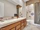 Double vanity bathroom with a tub and decorative tile at 3220 W Feather Sound Dr, Anthem, AZ 85086