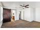 Spacious bedroom with ceiling fan, barn door, and ensuite bathroom at 2794 S Alpine Dr, Gilbert, AZ 85295