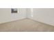 Spacious bedroom with neutral carpeting and large window at 37296 W Patterson St, Maricopa, AZ 85138