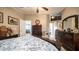 Well-lit bedroom with a queen-size bed and view into another room at 215 N Power Rd # 158, Mesa, AZ 85205