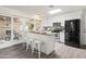 Updated kitchen with white cabinets, breakfast bar, and access to patio at 12030 N 36Th St, Phoenix, AZ 85028