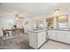 Modern kitchen with white cabinets, granite island, and access to patio at 12030 N 36Th St, Phoenix, AZ 85028