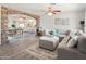 Open living room with L-shaped sofa, stone accent wall, and view to dining area at 12030 N 36Th St, Phoenix, AZ 85028