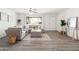 Bright living room featuring L-shaped sofa, large window, and wood-look floors at 12030 N 36Th St, Phoenix, AZ 85028