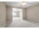 Spacious carpeted bedroom with neutral walls and ceiling fan at 12030 N 36Th St, Phoenix, AZ 85028