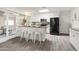 White kitchen with black appliances, granite counters, and breakfast bar at 12030 N 36Th St, Phoenix, AZ 85028