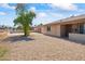 Ranch style home with a gravel front yard and mature tree at 12030 N 36Th St, Phoenix, AZ 85028
