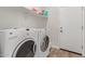 Laundry room with washer, dryer, and overhead shelving at 7930 W Pasadena Ave, Glendale, AZ 85303