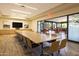 Bright and spacious community room with a large table and access to a patio at 8989 N Gainey Center Dr # 114, Scottsdale, AZ 85258