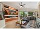 Spacious living room with a fireplace, large TV, and leather sectional sofa at 8989 N Gainey Center Dr # 114, Scottsdale, AZ 85258