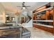 Open living area with a fireplace and hardwood floors, showcasing an elegant staircase at 8989 N Gainey Center Dr # 114, Scottsdale, AZ 85258