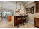 Gourmet kitchen with an island, custom cabinetry, and wine coolers at 8989 N Gainey Center Dr # 114, Scottsdale, AZ 85258