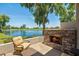 Peaceful patio with a fireplace overlooking a lake and golf course at 8989 N Gainey Center Dr # 114, Scottsdale, AZ 85258